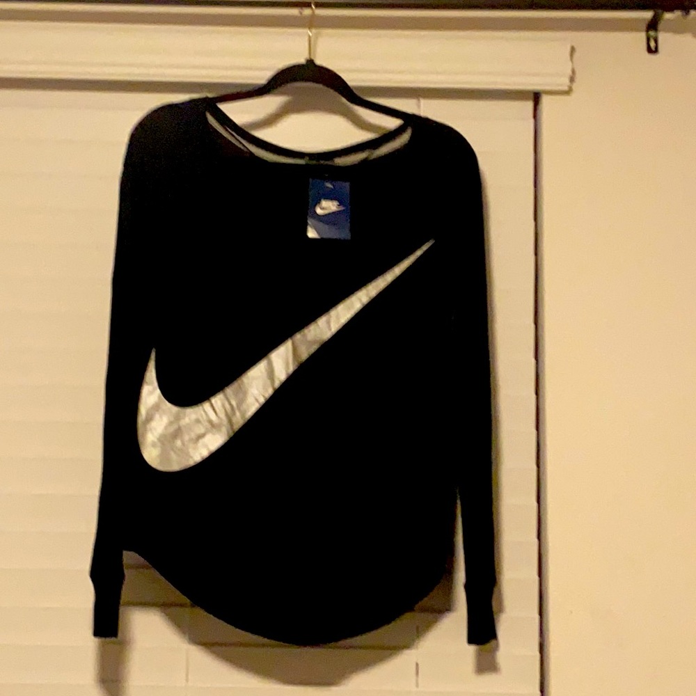 Women’s Nike size small NWT, black long sleeve shirt w Silver Nike symbol.